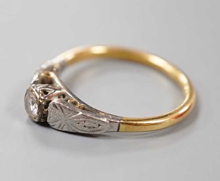 A yellow and white metal set solitaire diamond ring, size M, gross weight 3 grams.